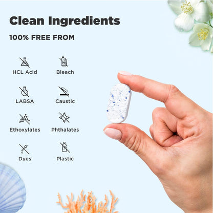 Tabbsz toilet cleaner tablet held between fingers, made with clean ingredients and 100% free from HCL acid, bleach, LABSA, caustic chemicals, ethoxylates, phthalates, dyes, and plastic; eco-friendly, non-toxic, plastic-free toilet cleaning solution.